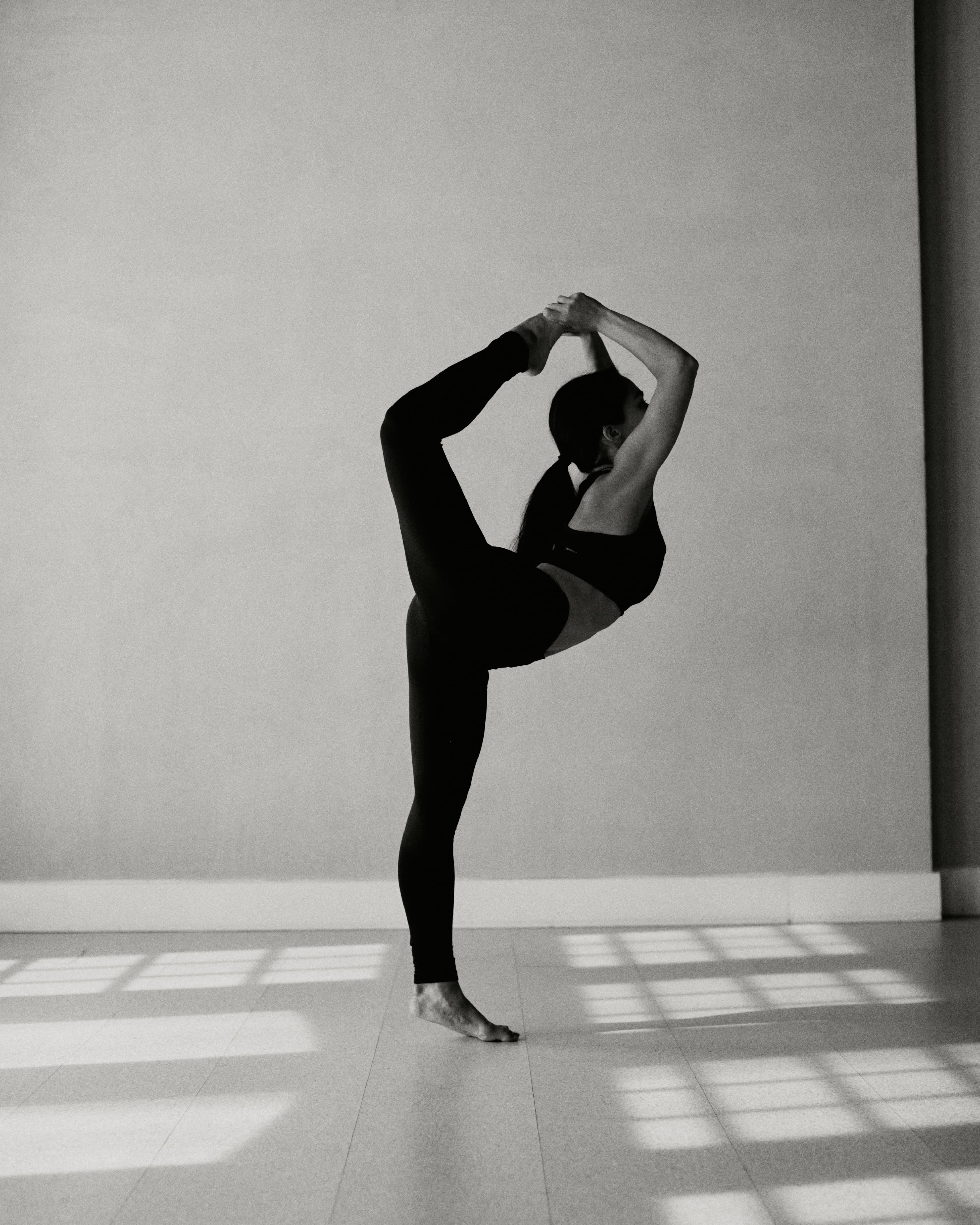 Yoga practitioner in dancer pose with beautiful natural light