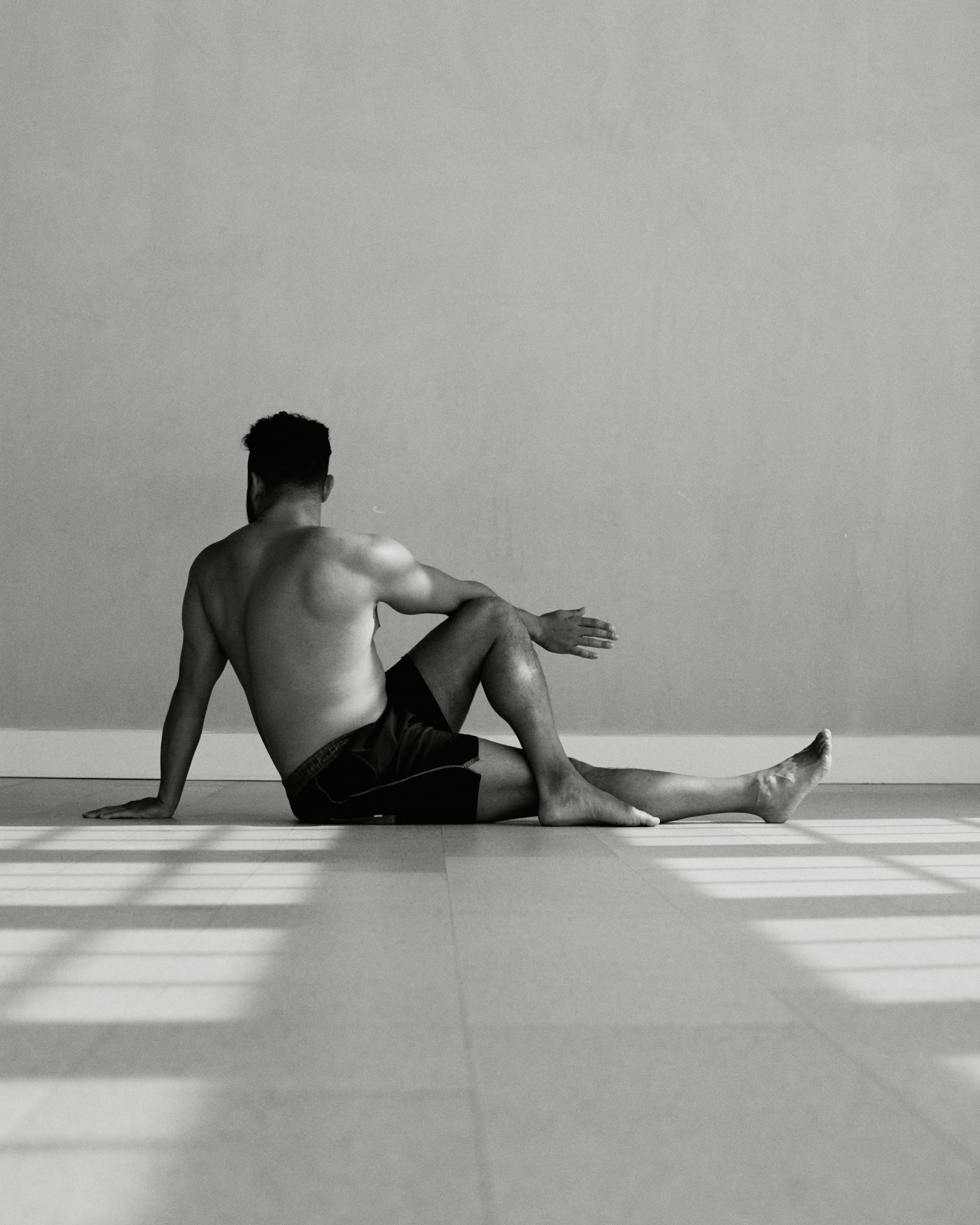 Practitioner seated on studio floor in natural light
