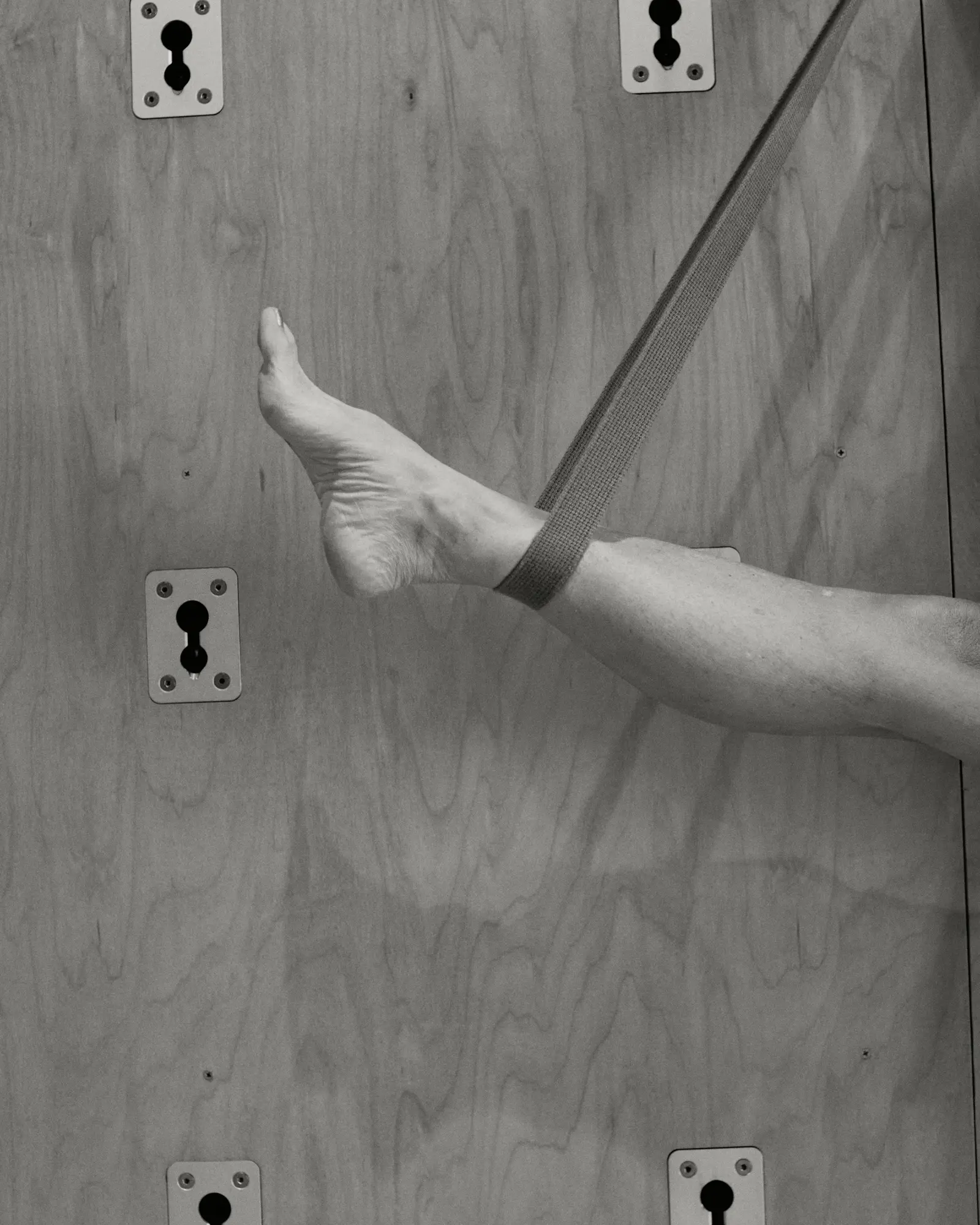 A student’s foot supported in a strap during a slow, supported pose