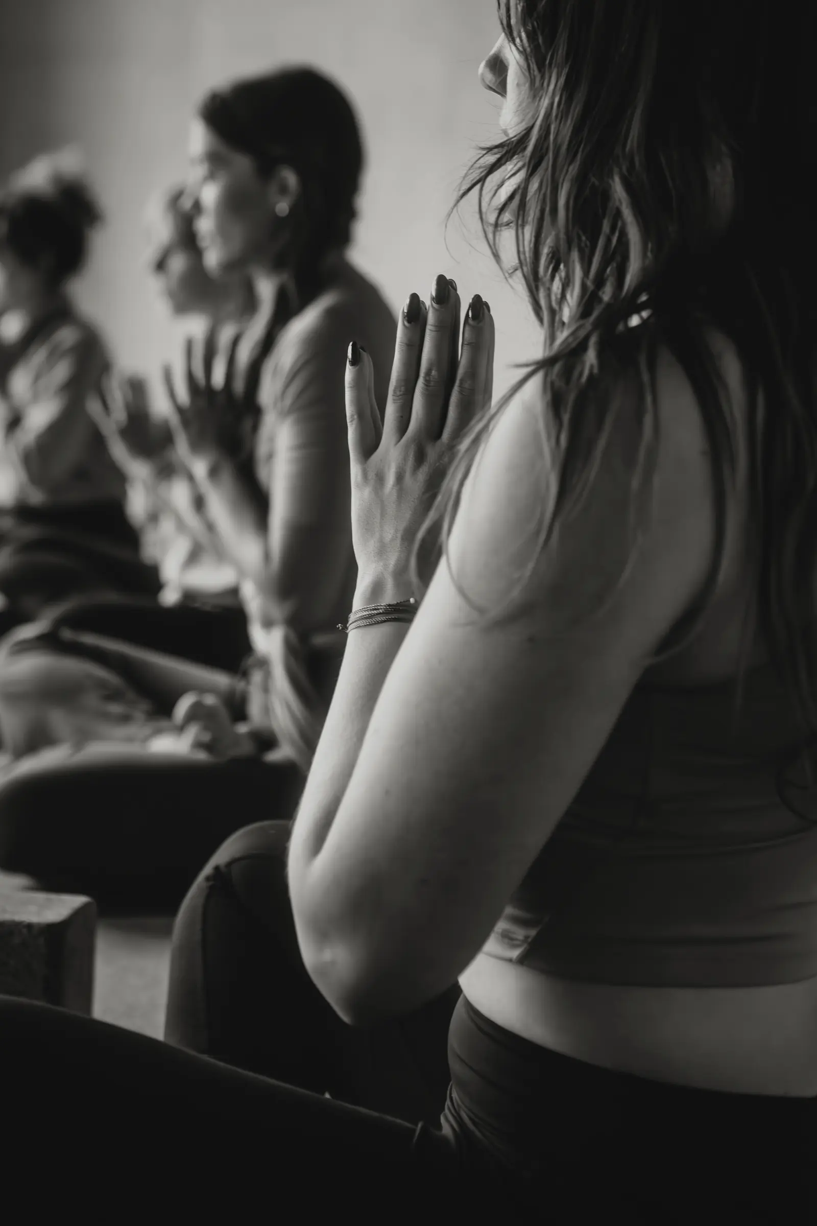 Students seated together with palms joined at 3B Movement